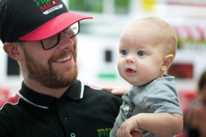 friendly butcher with his baby son